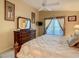 Bedroom with a large bed, dresser, mirror, and sliding glass doors to the outside, lit by lamps at 421 Bailey Cir, Davenport, FL 33897