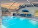 Enclosed backyard pool featuring ample seating and an outdoor grill for entertaining at 421 Bailey Cir, Davenport, FL 33897
