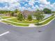 Home with great curb appeal, featuring a well-manicured lawn, mature palm trees, and an American flag at 4301 Mohawk Ct, St Cloud, FL 34772