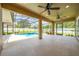 The back porch features a large open space with ceiling fans and a screened in pool area at 4301 Mohawk Ct, St Cloud, FL 34772