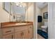 This bathroom includes a lovely vanity with light wood cabinets and a framed mirror at 4301 Mohawk Ct, St Cloud, FL 34772