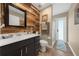 Modern bathroom featuring wood plank accent wall and walk-in shower at 4301 Mohawk Ct, St Cloud, FL 34772