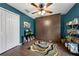 Bedroom with dark teal walls, a ceiling fan and a unique built-in storage unit at 4301 Mohawk Ct, St Cloud, FL 34772