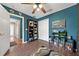 Bedroom with dark teal walls, ceiling fan and a bookcase with storage at 4301 Mohawk Ct, St Cloud, FL 34772