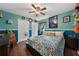 Vibrant bedroom with a ceiling fan and a plush bed with decorative pillows at 4301 Mohawk Ct, St Cloud, FL 34772