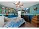 This bright bedroom features blue walls, wood floors and a flat screen television at 4301 Mohawk Ct, St Cloud, FL 34772
