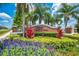 Entrance to Indian Lakes neighborhood, surrounded by vibrant flowers and greenery at 4301 Mohawk Ct, St Cloud, FL 34772