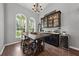 Formal dining area with ample natural light, wine storage, and views of the yard at 4301 Mohawk Ct, St Cloud, FL 34772