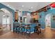 Open kitchen with bar-style seating and warm wood cabinetry, perfect for entertaining at 4301 Mohawk Ct, St Cloud, FL 34772