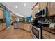 Spacious kitchen with wooden cabinets, stainless steel appliances, and views into living area at 4301 Mohawk Ct, St Cloud, FL 34772