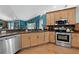 Well-equipped kitchen featuring stainless steel appliances, wooden cabinetry, and tiled floors at 4301 Mohawk Ct, St Cloud, FL 34772