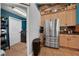 Kitchen with stainless steel appliances, wood cabinets, and adjacent laundry room at 4301 Mohawk Ct, St Cloud, FL 34772