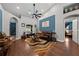 Inviting living room with blue accent wall, ceiling fan, and stylish, patterned rug at 4301 Mohawk Ct, St Cloud, FL 34772