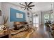 Bright living room featuring vaulted ceilings, blue accent wall, and hardwood floors at 4301 Mohawk Ct, St Cloud, FL 34772