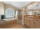Bathroom features a bathtub beneath a window plus a glass enclosed shower and a vanity at 4301 Mohawk Ct, St Cloud, FL 34772