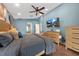 Comfortable main bedroom featuring a ceiling fan, TV, and doorway to the main bathroom at 4301 Mohawk Ct, St Cloud, FL 34772