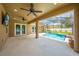 A spacious covered patio with ceiling fans, overlooking the pool and outdoor living space at 4301 Mohawk Ct, St Cloud, FL 34772