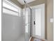 Bright shower with glass doors, white tiling, and natural light at 4301 Mohawk Ct, St Cloud, FL 34772