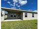 The backyard offers a covered patio and an expanse of green lawn at 4310 Seven Canyons Dr, Kissimmee, FL 34746