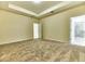 Spacious bedroom features neutral carpeting and a tray ceiling at 4310 Seven Canyons Dr, Kissimmee, FL 34746