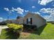A beautiful home with a well-manicured lawn and landscaping under a sunny, blue sky at 4310 Seven Canyons Dr, Kissimmee, FL 34746
