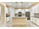 Bright kitchen with stainless steel appliances, an island, and white cabinets at 4310 Seven Canyons Dr, Kissimmee, FL 34746