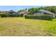 View of several screened-in backyards surrounded by a mature green hedge and lush green lawn for privacy and enjoyment at 4413 Chalfont Dr, Orlando, FL 32837