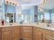 Bathroom showcases a double sink vanity with ample lighting and lots of mirror space at 4413 Chalfont Dr, Orlando, FL 32837