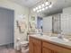 Bright bathroom features a double sink vanity with tile flooring and ample lighting at 4413 Chalfont Dr, Orlando, FL 32837