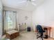 Inviting bedroom features a ceiling fan, window, and a cozy sitting area at 4413 Chalfont Dr, Orlando, FL 32837