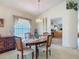 Comfortable dining area featuring a wooden table, with views of the open kitchen at 4413 Chalfont Dr, Orlando, FL 32837