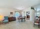 Bright dining area featuring a dining table set for four, a stylish sideboard, and an adjacent view into the kitchen at 4413 Chalfont Dr, Orlando, FL 32837