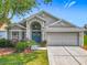 Charming single-story home featuring a well-manicured lawn and double front doors with decorative wreaths at 4413 Chalfont Dr, Orlando, FL 32837