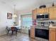 Eat-in kitchen with stainless steel appliances, tile flooring, and a charming breakfast nook at 4413 Chalfont Dr, Orlando, FL 32837