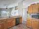 Bright kitchen with light wood cabinets, stainless steel dishwasher, and tile flooring at 4413 Chalfont Dr, Orlando, FL 32837