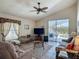 Living room with tile floors, vaulted ceiling, ceiling fan, and sliding glass doors to patio at 4413 Chalfont Dr, Orlando, FL 32837