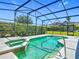 Inviting screened-in pool and spa featuring clear turquoise water and a spacious deck for outdoor relaxation and enjoyment at 4413 Chalfont Dr, Orlando, FL 32837
