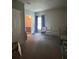 Neutral bedroom featuring a large window with curtains and adjacent bathroom at 4714 Greycliff Prairie Dr, Kissimmee, FL 34758