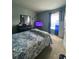 Cozy bedroom with neutral walls and a window with a decorative curtain at 4714 Greycliff Prairie Dr, Kissimmee, FL 34758