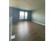 Open bonus room with wood floors and ample natural light from the windows at 4714 Greycliff Prairie Dr, Kissimmee, FL 34758