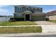Two-story home with a two car garage, manicured front yard and brick driveway at 4714 Greycliff Prairie Dr, Kissimmee, FL 34758
