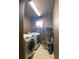 Functional laundry room equipped with a washer, dryer, and storage shelving at 4714 Greycliff Prairie Dr, Kissimmee, FL 34758