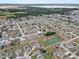 High aerial of the home, showcasing neighborhood, the nearby pond, and landscape at 491 Majestic Gardens Blvd, Winter Haven, FL 33880