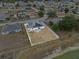 Aerial view of the home and backyard showcasing solar panels, pond, and surrounding community at 491 Majestic Gardens Blvd, Winter Haven, FL 33880