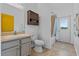 Bathroom with grey cabinets, shower with glass doors, and an exterior door for added convenience at 491 Majestic Gardens Blvd, Winter Haven, FL 33880