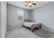 Bedroom with a simple bed, neutral decor, carpet and a ceiling fan at 491 Majestic Gardens Blvd, Winter Haven, FL 33880