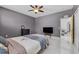 Bedroom featuring tile flooring, and grey walls, view into ensuite bathroom at 491 Majestic Gardens Blvd, Winter Haven, FL 33880