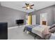 The Main Bedroom features tile floors, grey walls, ceiling fan, and attached ensuite at 491 Majestic Gardens Blvd, Winter Haven, FL 33880