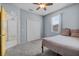 Cozy bedroom with ceiling fan, carpet, simple bed, and closet at 491 Majestic Gardens Blvd, Winter Haven, FL 33880