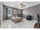 Spacious Bedroom with grey walls, ceiling fan, tile floors, and windows providing natural light at 491 Majestic Gardens Blvd, Winter Haven, FL 33880
